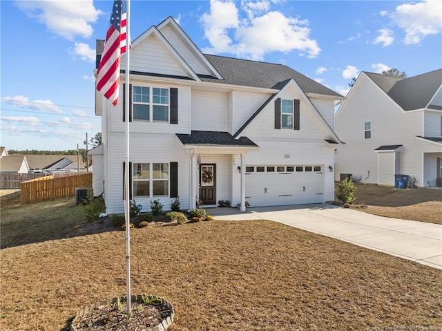 view of front of property with a garage, a front yard, and central air condition unit