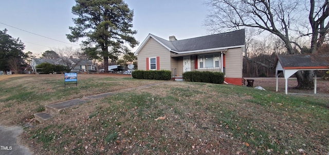 exterior space featuring covered porch and a yard