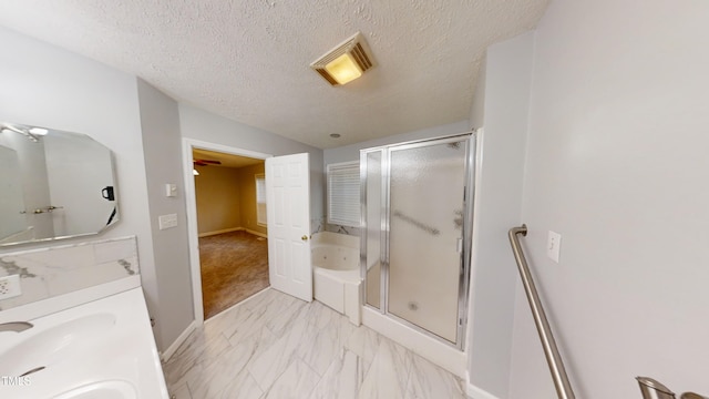 bathroom featuring vanity, a textured ceiling, and independent shower and bath