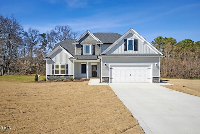 craftsman inspired home with a garage and a front yard