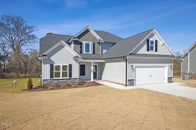 craftsman-style home featuring central AC and a front yard