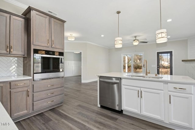 kitchen featuring white cabinetry, ornamental molding, stainless steel appliances, and sink