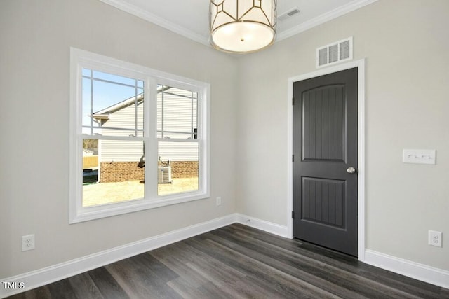 unfurnished room featuring crown molding, dark hardwood / wood-style floors, and a wealth of natural light