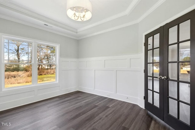 empty room with french doors, an inviting chandelier, crown molding, a tray ceiling, and dark hardwood / wood-style flooring