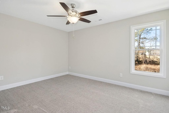 carpeted spare room with ceiling fan