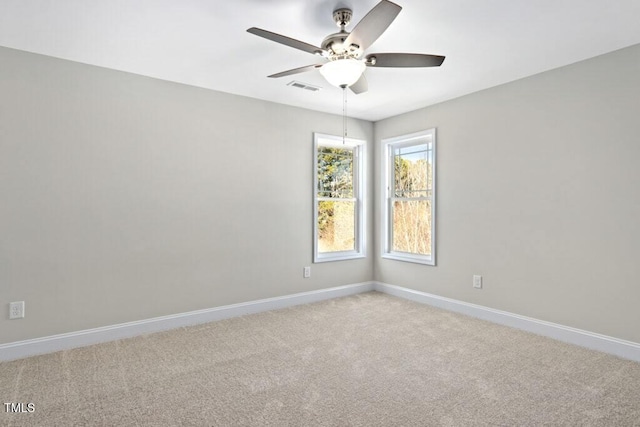 spare room with light carpet and ceiling fan