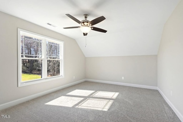 bonus room featuring lofted ceiling, a healthy amount of sunlight, and carpet flooring