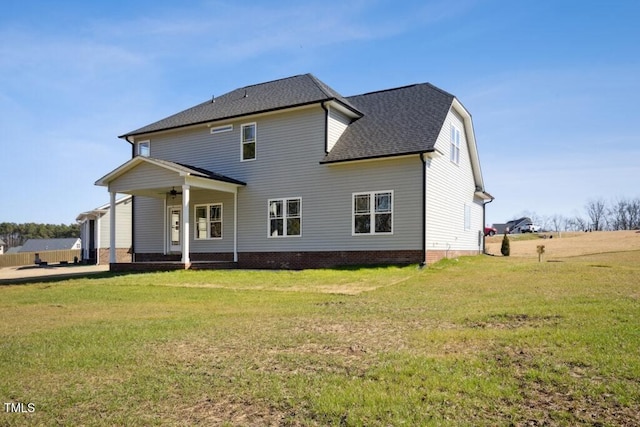 back of house featuring a lawn