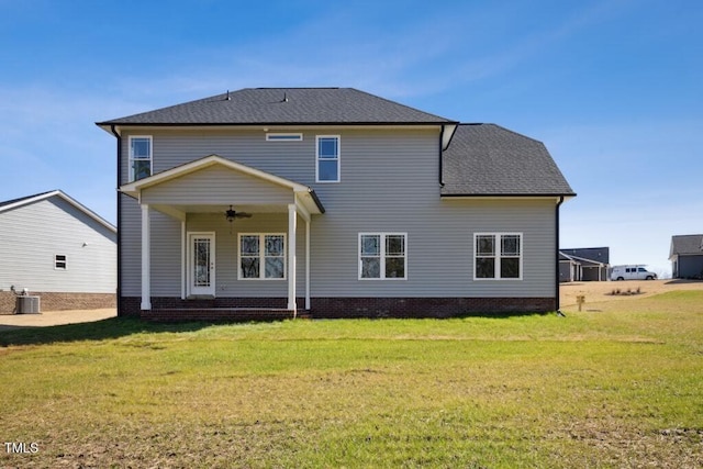 back of house with ceiling fan, a yard, and central air condition unit