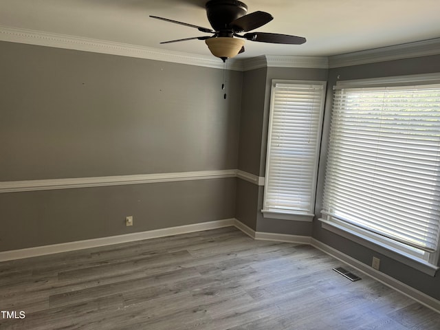 unfurnished room with wood-type flooring, ceiling fan, and crown molding