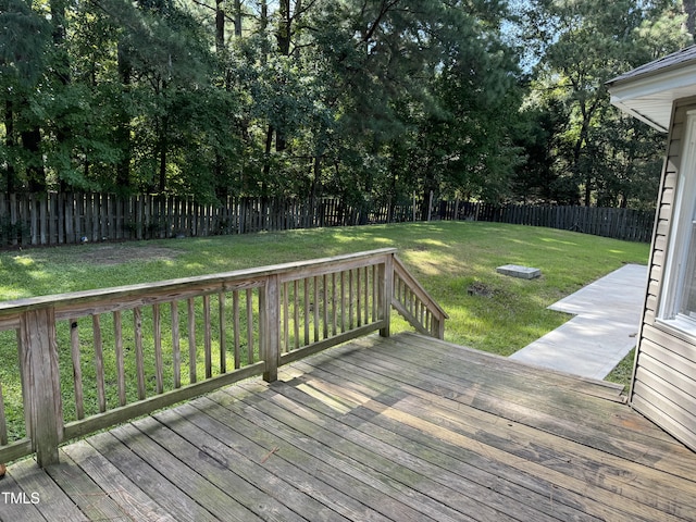 wooden deck featuring a lawn