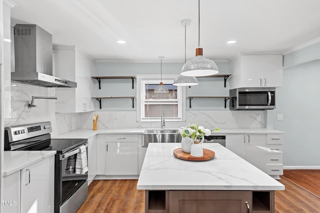 kitchen featuring white cabinets, wall chimney exhaust hood, wood-type flooring, and appliances with stainless steel finishes