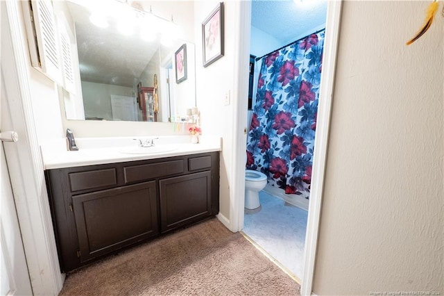 bathroom with a textured ceiling, vanity, toilet, and walk in shower