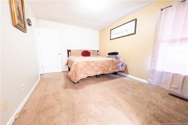 bedroom with carpet flooring and a textured ceiling