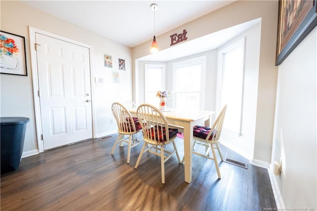 dining area with dark hardwood / wood-style flooring