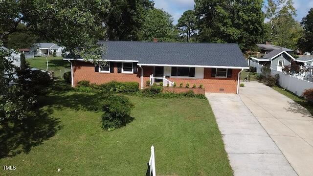 ranch-style home with a front lawn