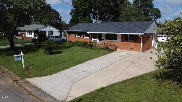 ranch-style home with a front lawn