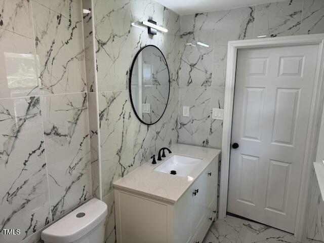 bathroom featuring toilet and vanity