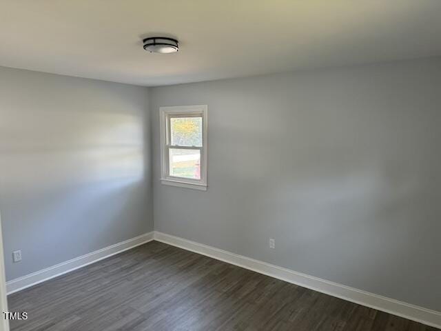 unfurnished room with dark hardwood / wood-style floors