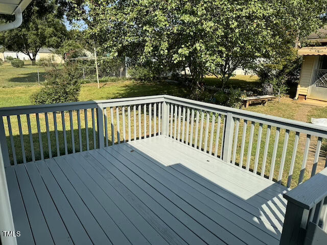 wooden terrace with a lawn