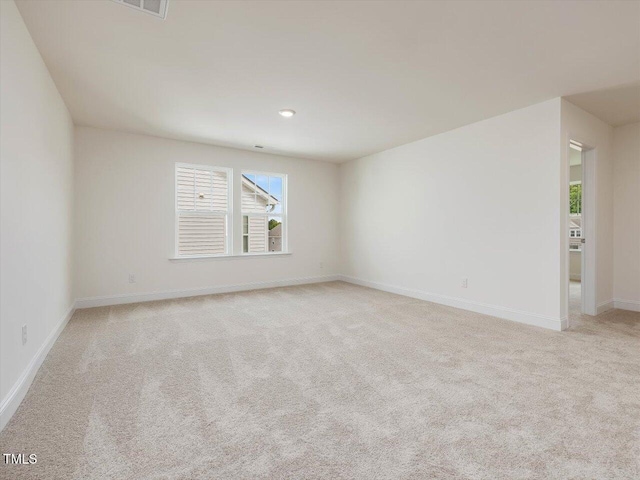 empty room with baseboards and light colored carpet