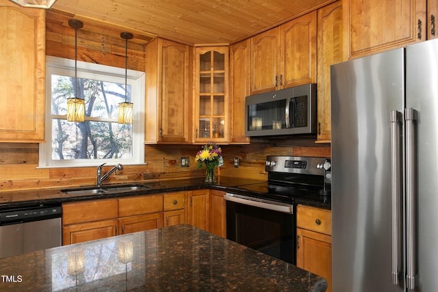 kitchen with sink, hanging light fixtures, stainless steel appliances, dark stone countertops, and wood ceiling