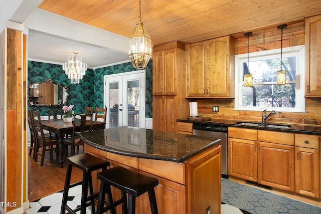 kitchen with dishwasher, a center island, french doors, sink, and hanging light fixtures