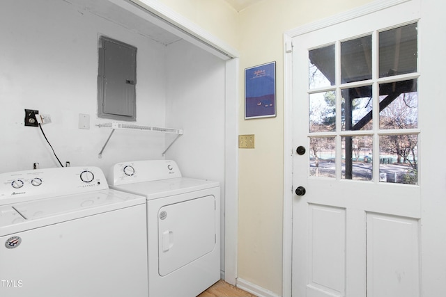 laundry room featuring electric panel and washer and clothes dryer