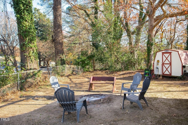 view of yard with a storage unit and an outdoor fire pit