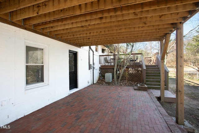 view of patio featuring central AC unit and a wooden deck