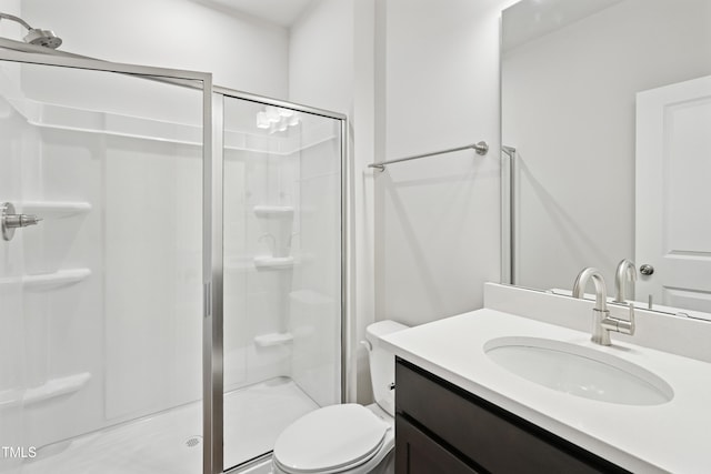 full bathroom featuring toilet, a stall shower, and vanity