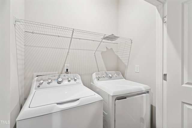 laundry area with separate washer and dryer