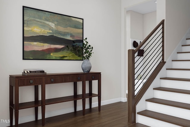 staircase featuring baseboards and wood finished floors