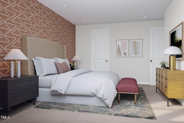 bedroom with baseboards, carpet floors, wallpapered walls, recessed lighting, and an accent wall