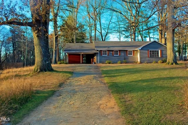 single story home with driveway, a garage, and a front yard