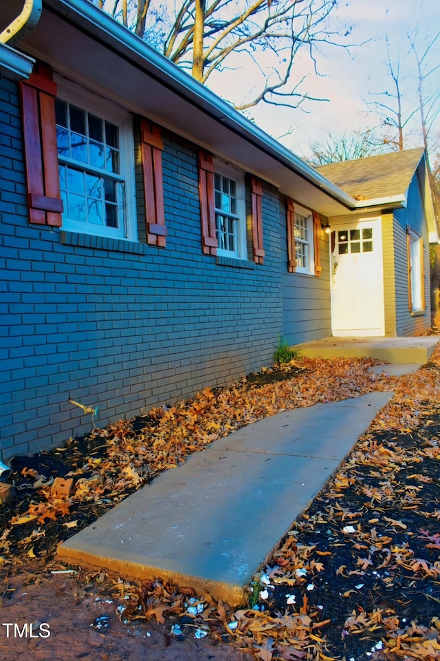 view of side of property featuring brick siding