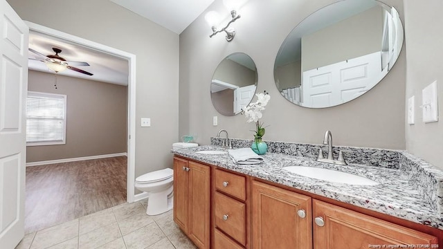 full bath with double vanity, a ceiling fan, a sink, and tile patterned floors