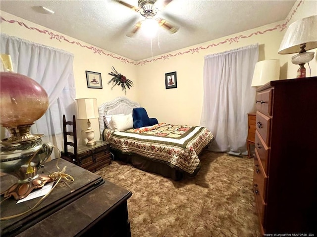 bedroom with carpet flooring, ceiling fan, and a textured ceiling