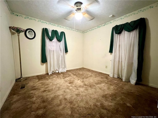 spare room with a textured ceiling, carpet floors, and ceiling fan