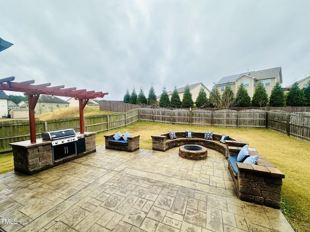 view of patio with a grill, area for grilling, and an outdoor fire pit