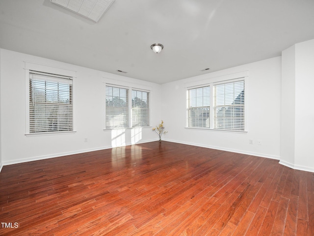 unfurnished room with wood-type flooring