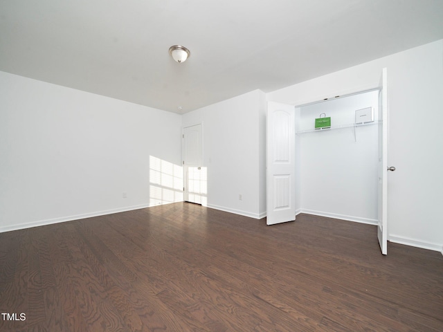 spare room featuring dark hardwood / wood-style floors