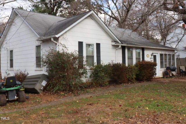 view of property exterior with a lawn