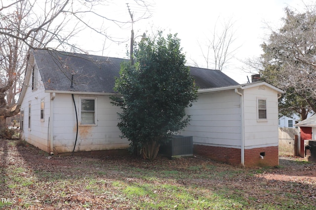 view of side of home with central AC unit