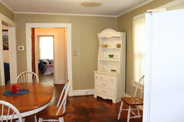 dining space featuring dark hardwood / wood-style flooring and ornamental molding