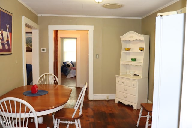 dining room featuring dark hardwood / wood-style flooring and ornamental molding