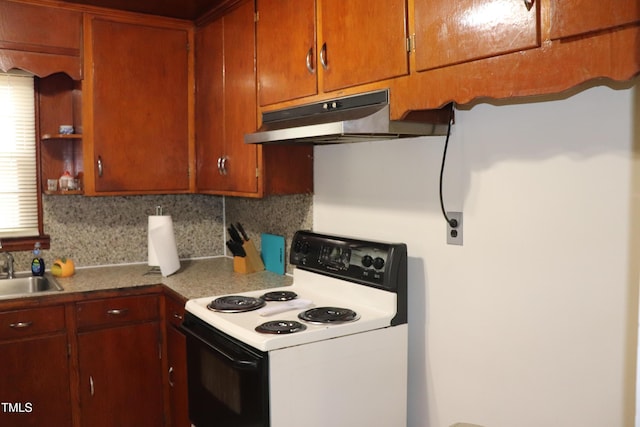 kitchen featuring electric range, sink, and tasteful backsplash