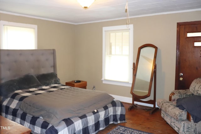 bedroom with hardwood / wood-style floors and ornamental molding