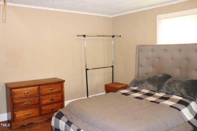 bedroom featuring hardwood / wood-style flooring and ornamental molding