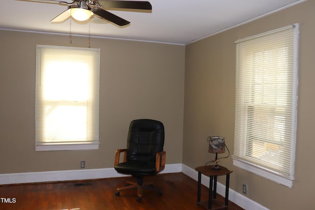 living area with ceiling fan, plenty of natural light, hardwood / wood-style floors, and ornamental molding